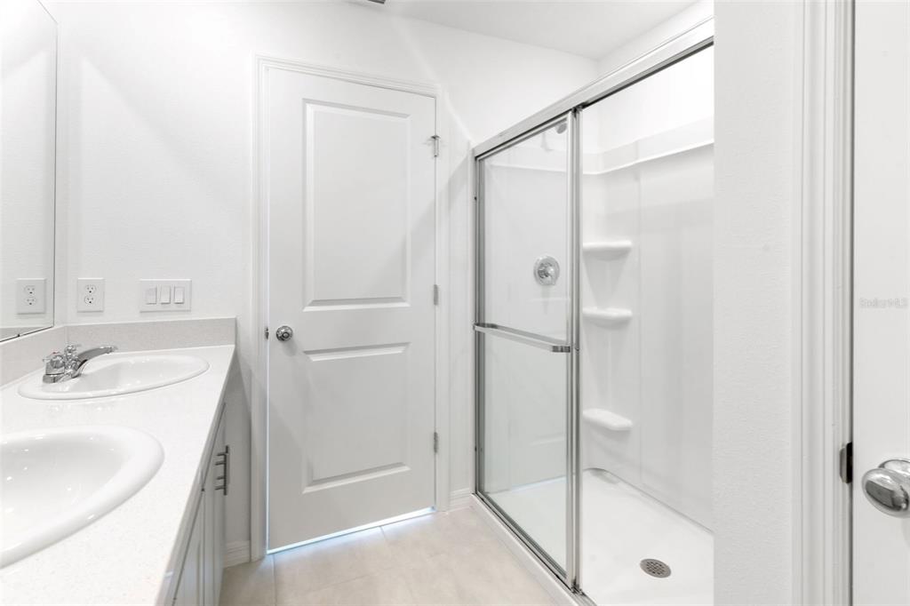 2987 Skyline Loop Kissimmee, FL 34758 - Photo 28 of 48 a bathroom with a shower sink vanity and mirror