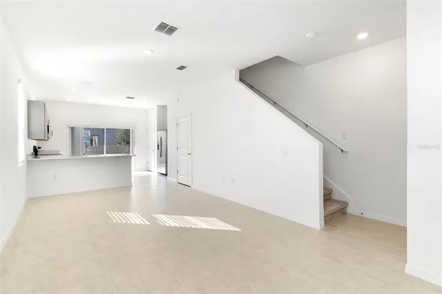 a view of a kitchen with furniture and wooden floor