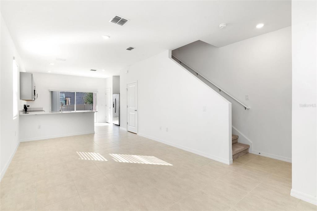 2987 Skyline Loop Kissimmee, FL 34758 - Photo 3 of 48 a view of a kitchen with furniture and wooden floor