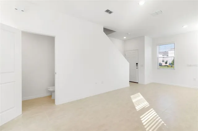 a view of an empty room with a window