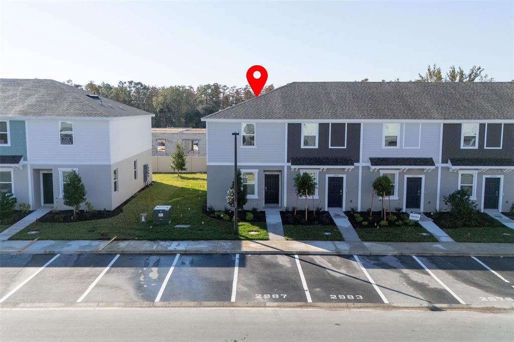 2987 Skyline Loop Kissimmee, FL 34758 - Photo 46 of 48 a front view of a house with yard
