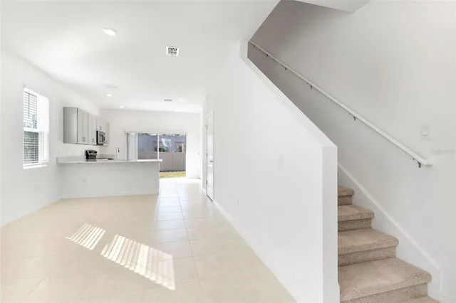 a view of kitchen and hall with wooden floor