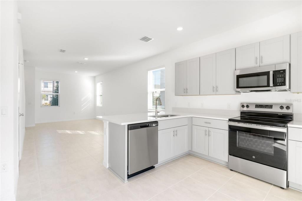 2987 Skyline Loop Kissimmee, FL 34758 - Photo 10 of 48 a kitchen with granite countertop a sink and stainless steel appliances