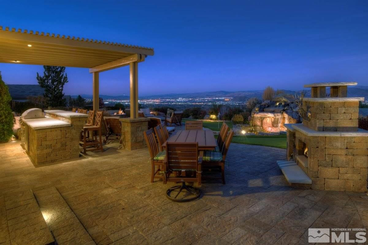 544 Echo Ridge Court Reno, NV 89511 - Photo 34 of 39 a view of a patio with couches and table and chairs under an umbrella