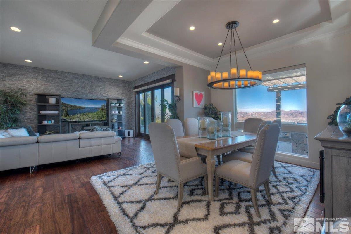 544 Echo Ridge Court Reno, NV 89511 - Photo 6 of 39 a dining room with wooden floor a chandelier a glass table and chairs