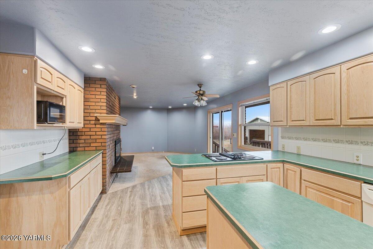 1861 North Cottonwood Road Yakima, WA 98908 - Photo 15 of 35 a kitchen with kitchen island granite countertop a stove and a sink