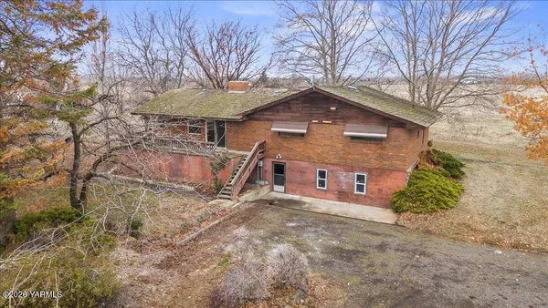 a front view of a house with a yard covered in snow
