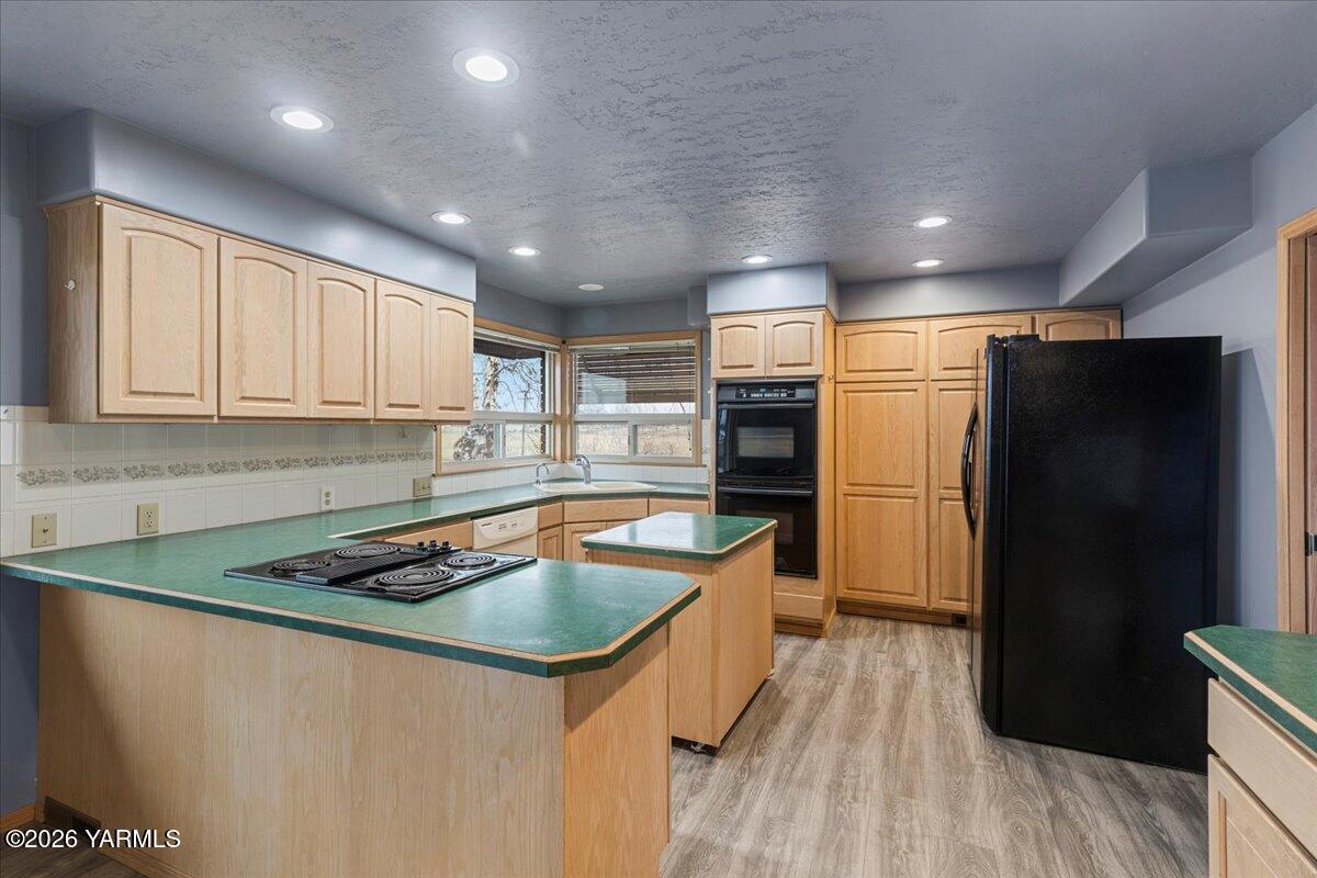 1861 North Cottonwood Road Yakima, WA 98908 - Photo 9 of 35 a kitchen that has a sink stainless steel appliances a counter space and cabinets