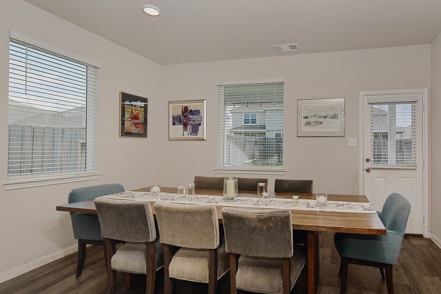 14022 Chinook Drive Conroe, TX 77384 - Photo 11 of 25 a kitchen with granite countertop a dining table chairs and a wooden floor