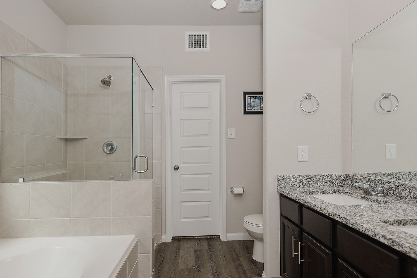 14022 Chinook Drive Conroe, TX 77384 - Photo 14 of 25 a bathroom with a granite countertop sink a toilet and shower