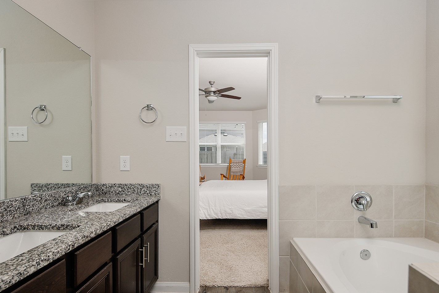 14022 Chinook Drive Conroe, TX 77384 - Photo 15 of 25 a en suite bathroom with a granite countertop sink and a bathtub