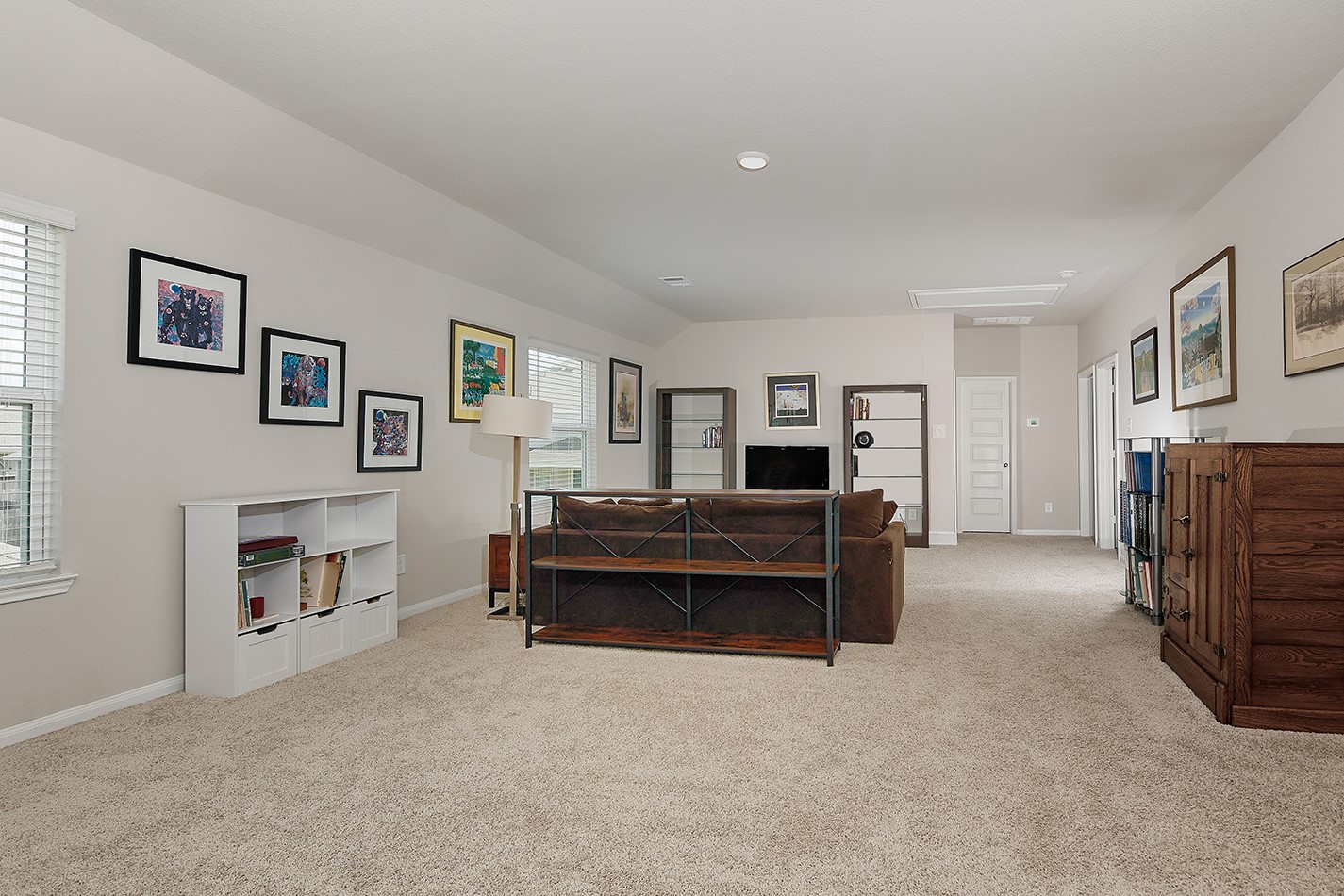 14022 Chinook Drive Conroe, TX 77384 - Photo 17 of 25 a living room with furniture and a baby crib with a chair