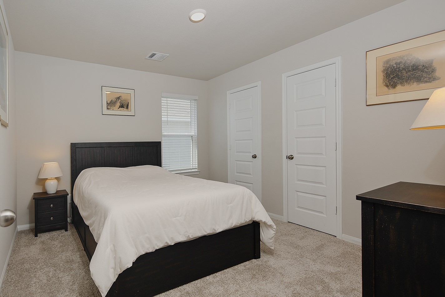 14022 Chinook Drive Conroe, TX 77384 - Photo 19 of 25 a bedroom with a bed and wall painting