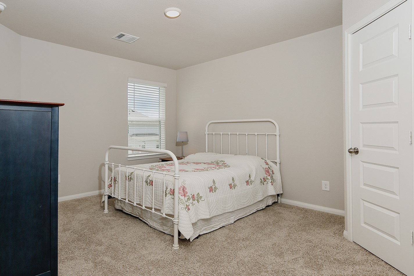 14022 Chinook Drive Conroe, TX 77384 - Photo 20 of 25 a bed sitting in a bedroom next to a window
