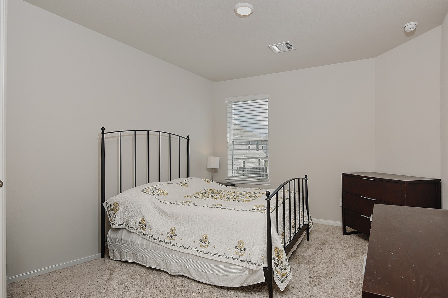14022 Chinook Drive Conroe, TX 77384 - Photo 22 of 25 a bedroom with a bed and a dresser