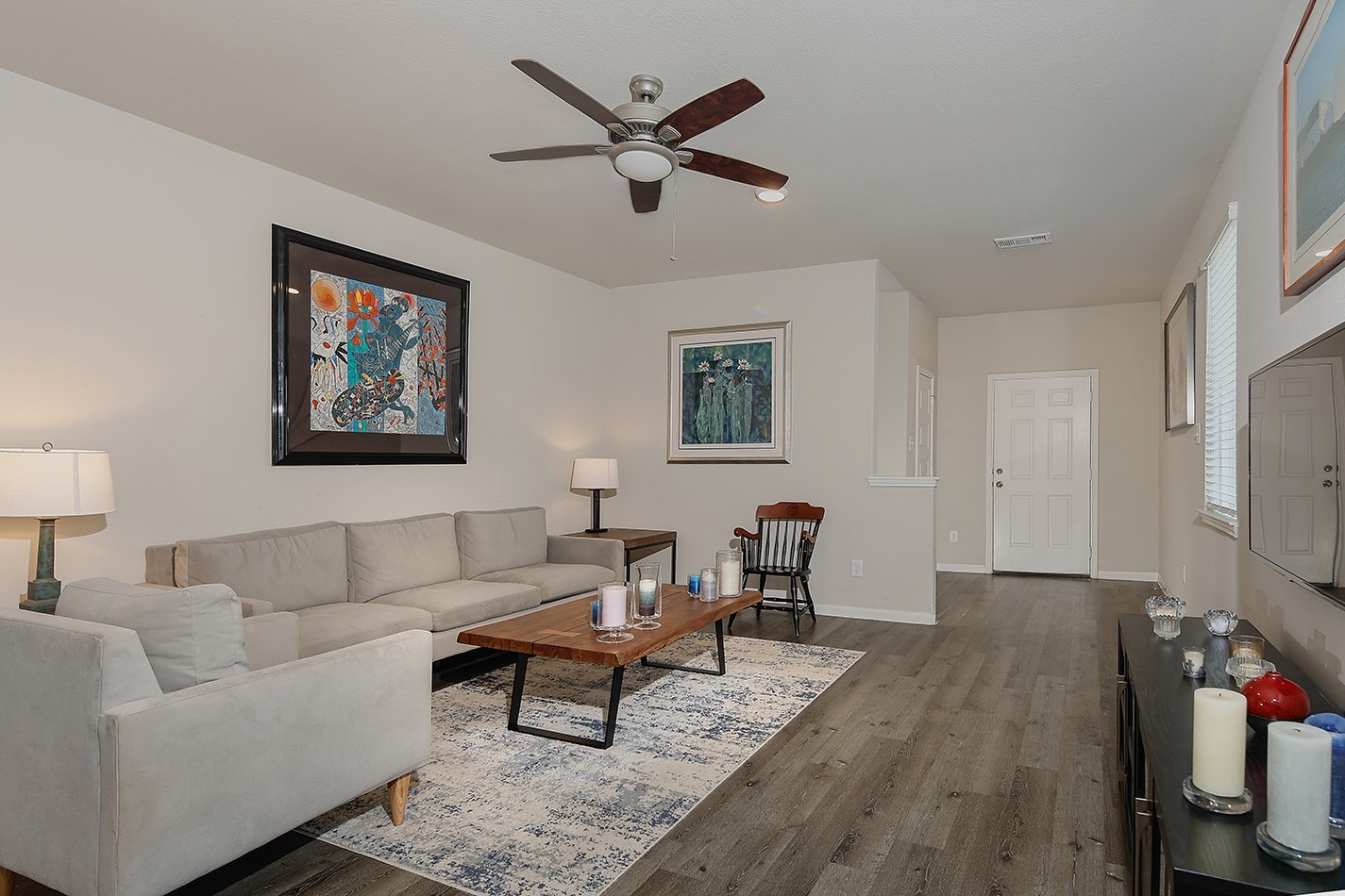 14022 Chinook Drive Conroe, TX 77384 - Photo 6 of 25 a living room with furniture a rug and a ceiling fan