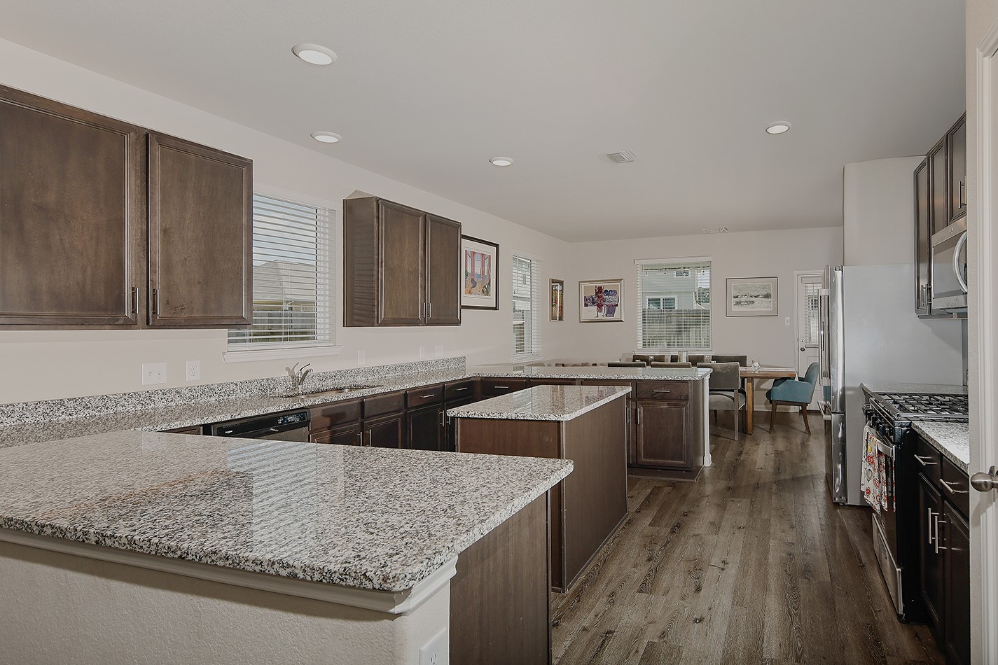 14022 Chinook Drive Conroe, TX 77384 - Photo 7 of 25 a kitchen with lots of counter space and wooden floor