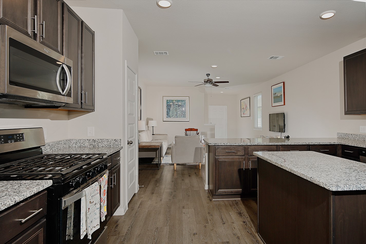 14022 Chinook Drive Conroe, TX 77384 - Photo 9 of 25 a kitchen with a stove sink and microwave