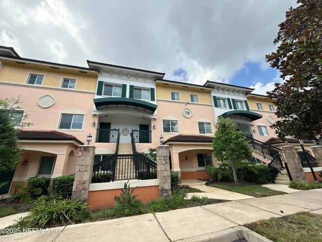 a front view of a residential apartment building with a yard