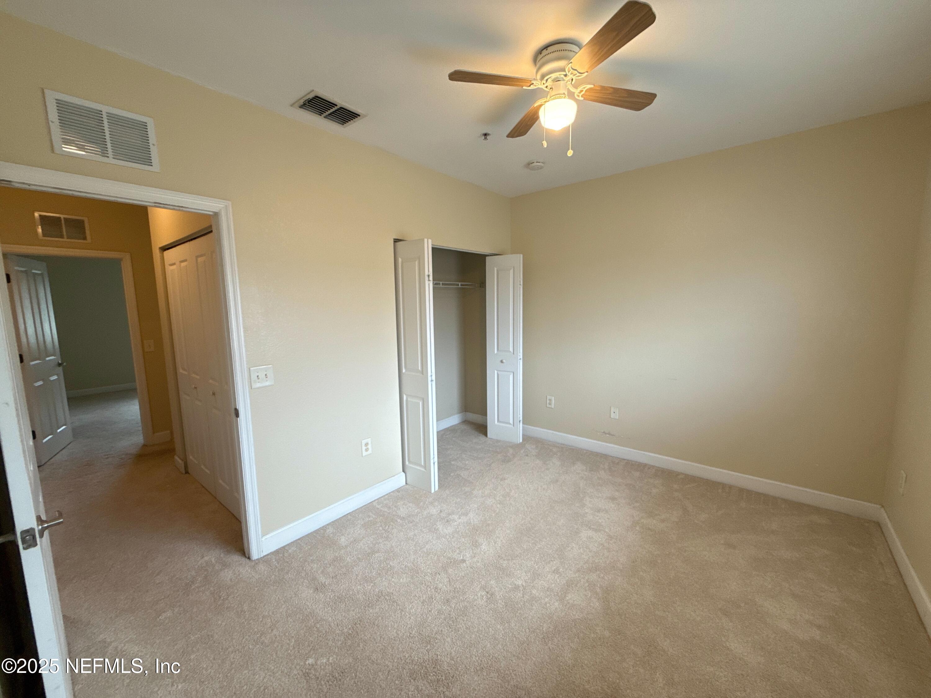 9745 Touchton Road, Unit 1725 Jacksonville, FL 32246 - Photo 11 of 20 a view of an empty room and a ceiling fan
