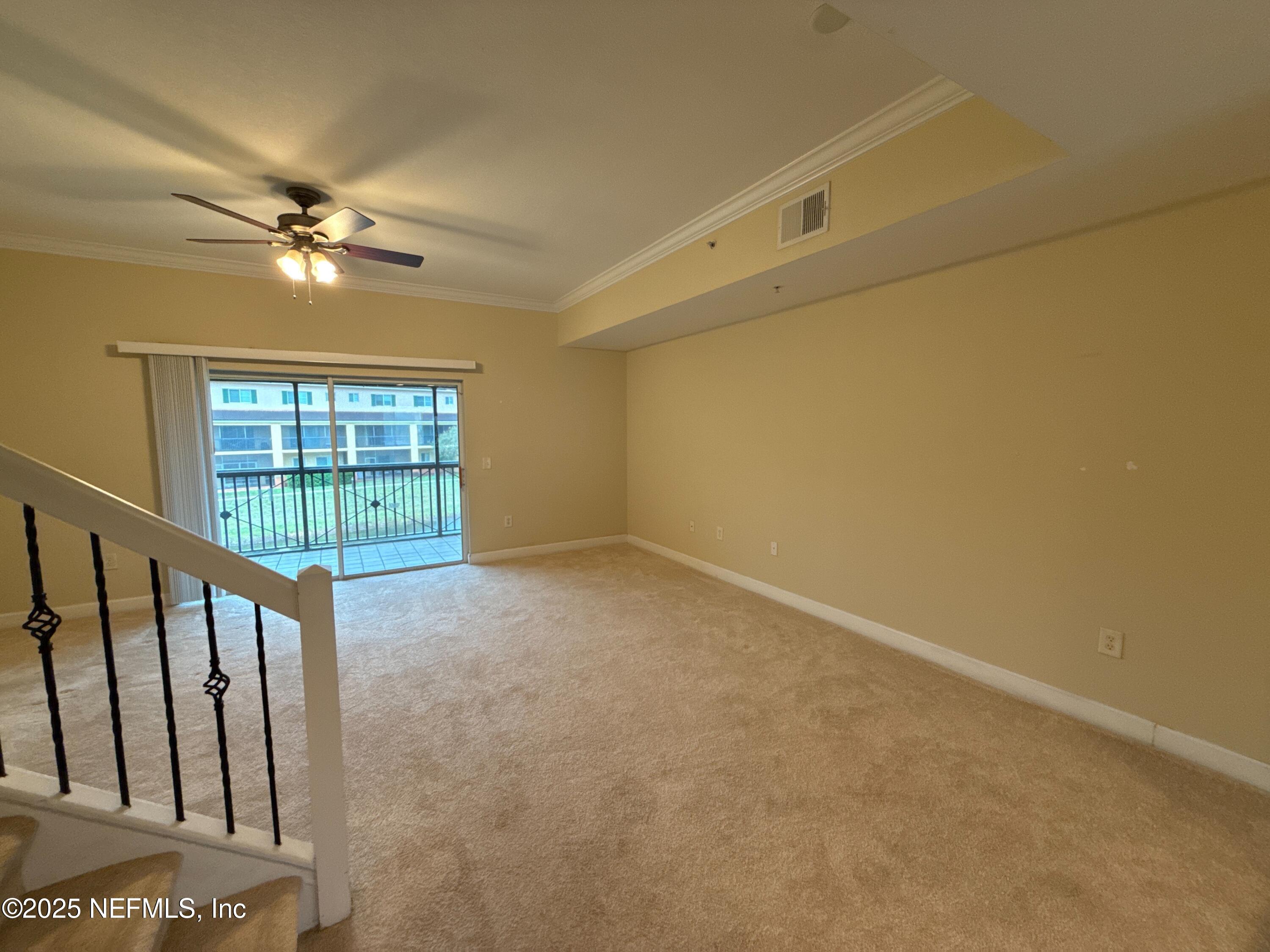 9745 Touchton Road, Unit 1725 Jacksonville, FL 32246 - Photo 5 of 20 an empty room with windows and fan