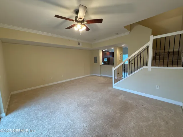 a view of an empty room with stairs