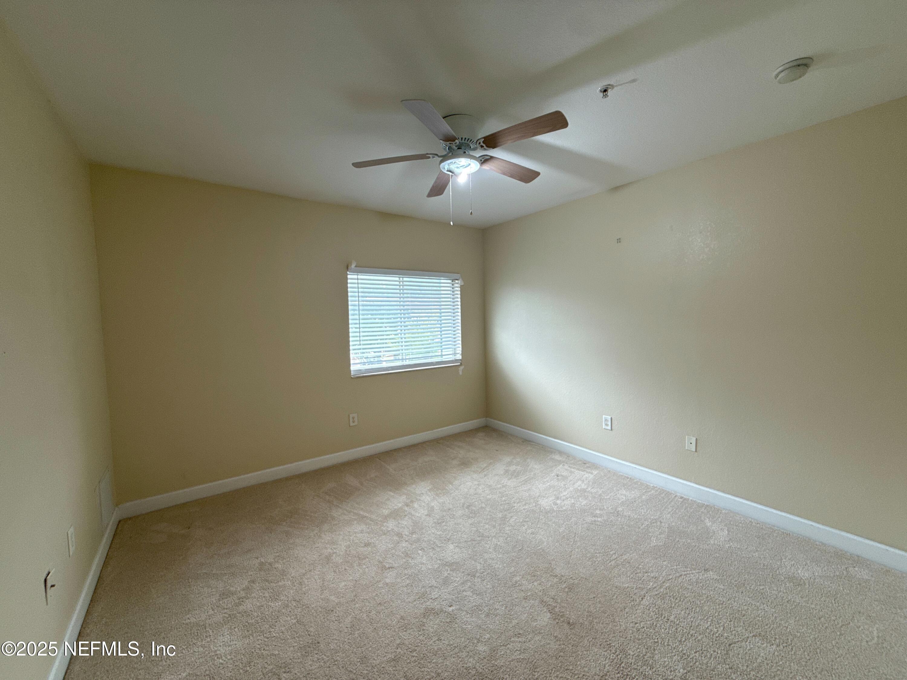 9745 Touchton Road, Unit 1725 Jacksonville, FL 32246 - Photo 8 of 20 an empty room with a window and a fan
