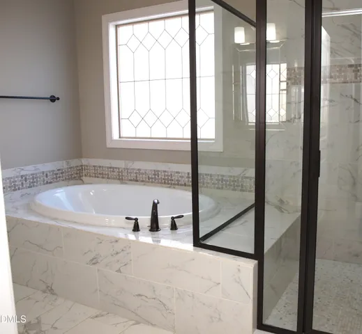 a bath tub sitting next to a window