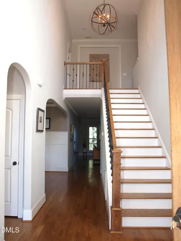 a view of entryway and hall with wooden floor