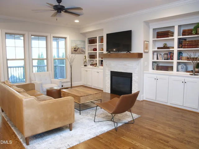 a living room with furniture fireplace and flat screen tv