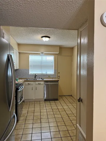 a kitchen with stainless steel appliances a refrigerator and a sink