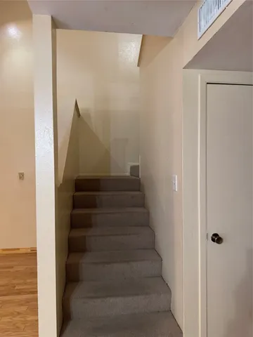 a view of staircase with white walls