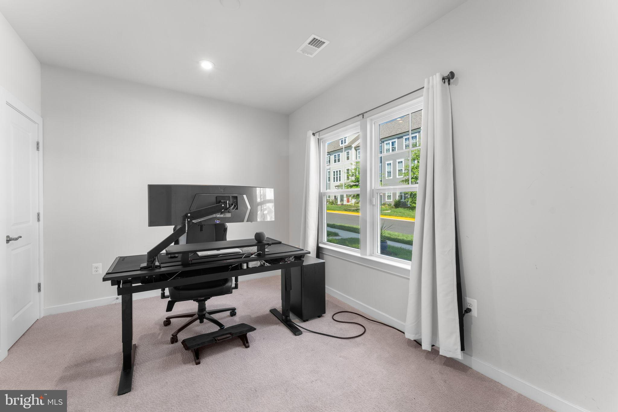 1783 Hickory Woods Road Dumfries, VA 22026 - Photo 20 of 54 a view of a workspace with furniture and a window