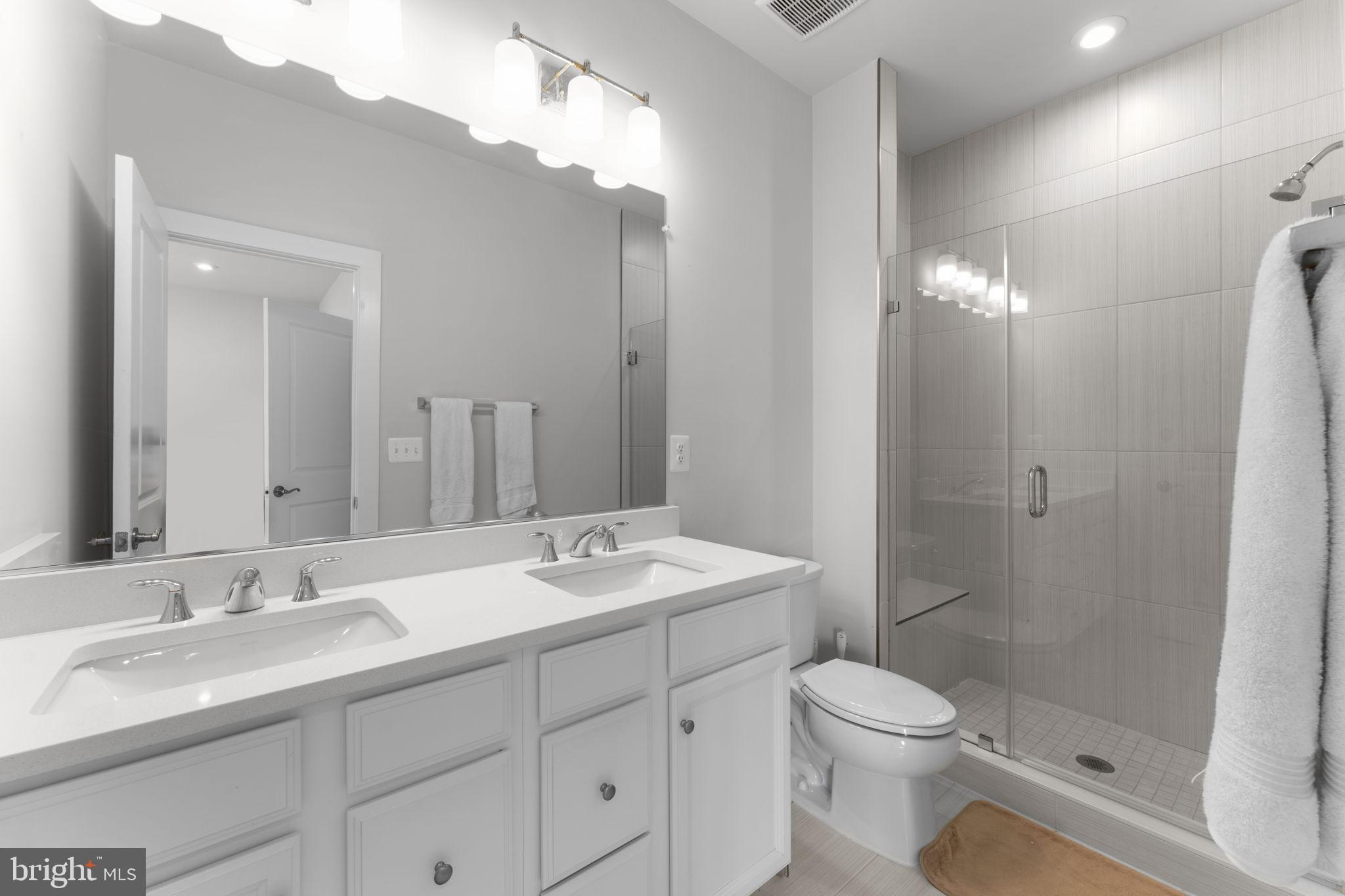 1783 Hickory Woods Road Dumfries, VA 22026 - Photo 26 of 54 a bathroom with a toilet a sink a mirror a vanity and shower