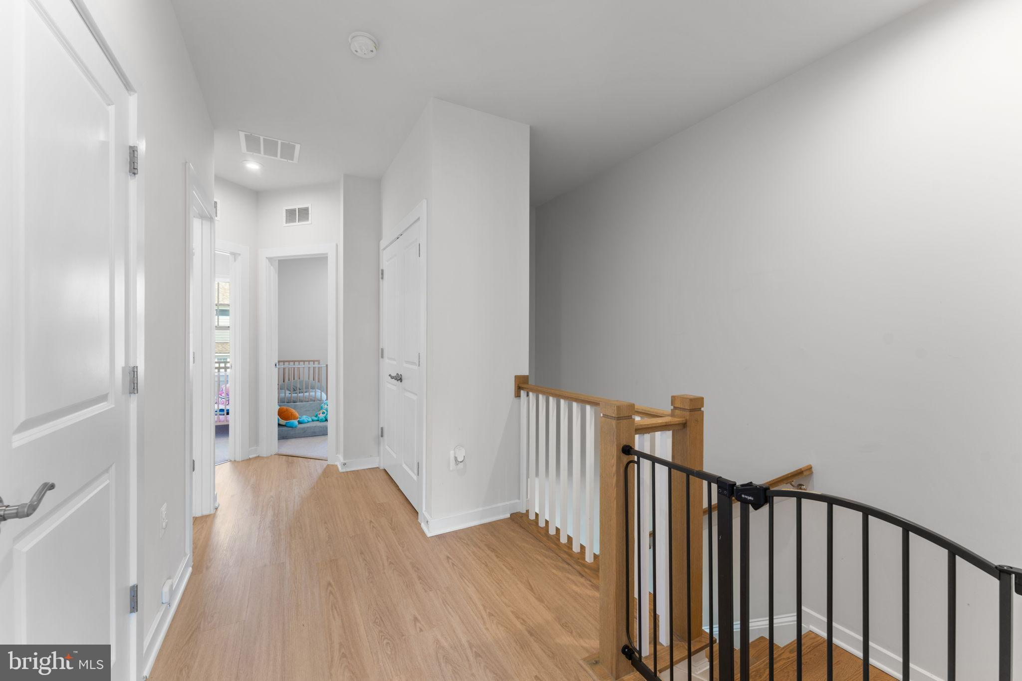 1783 Hickory Woods Road Dumfries, VA 22026 - Photo 35 of 54 a view of a hallway with wooden floor and a bathroom