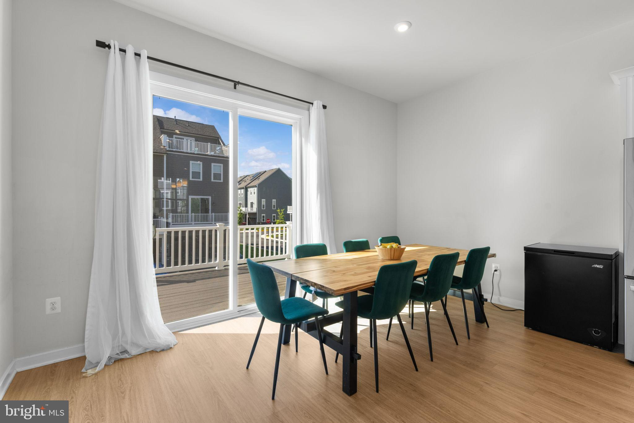 1783 Hickory Woods Road Dumfries, VA 22026 - Photo 9 of 54 a view of a dining room with furniture and wooden floor