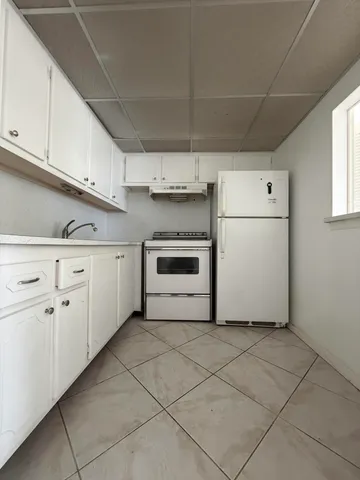 a utility room with cabinets washer and dryer