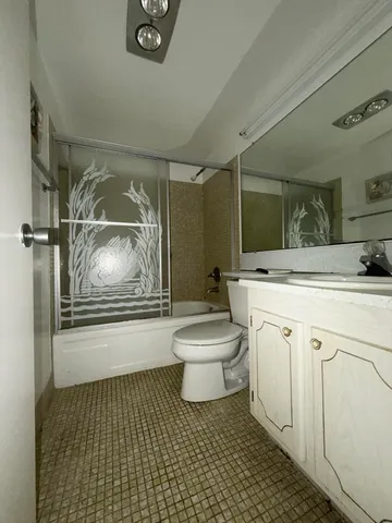 a bathroom with a sink toilet and mirror
