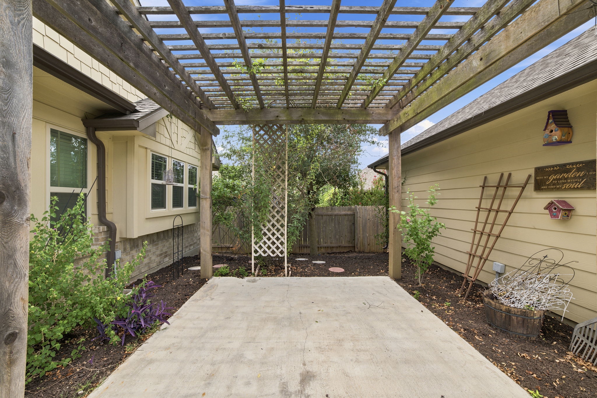 514 Nautical Loop Kyle, TX 78640 - Photo 12 of 24 A private backyard patio with a wooden pergola invites outdoor relaxation.
