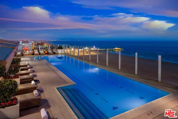 a outdoor living room with furniture and a city view