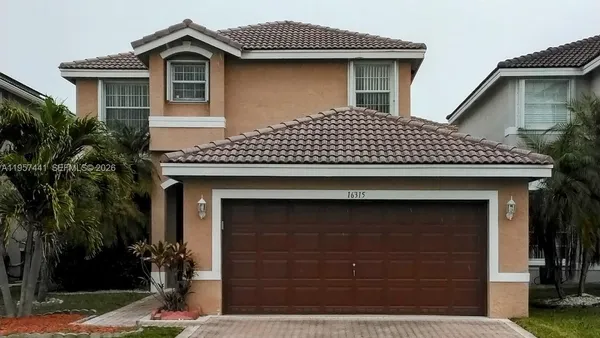 a front view of a house with a garage