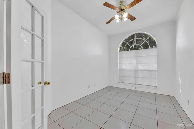 a view of a room with a ceiling fan