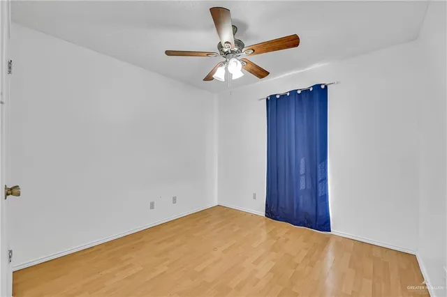 a bathroom with a granite countertop sink a toilet and a window