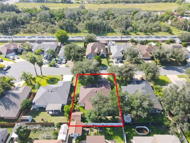 an aerial view of a houses with yard