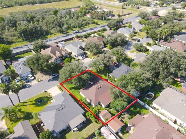 an aerial view of a house with a yard and lake view