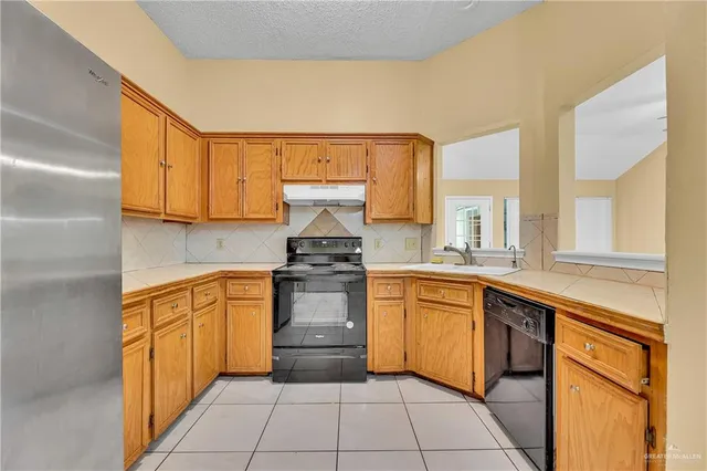a kitchen with stainless steel appliances granite countertop a sink and cabinets
