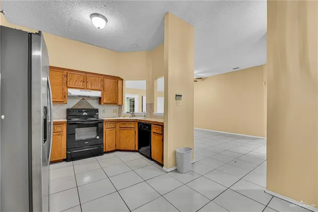 a kitchen with a stove top oven and cabinets