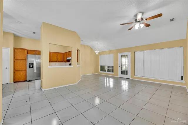a view of a livingroom with wooden floor and a ceiling fan