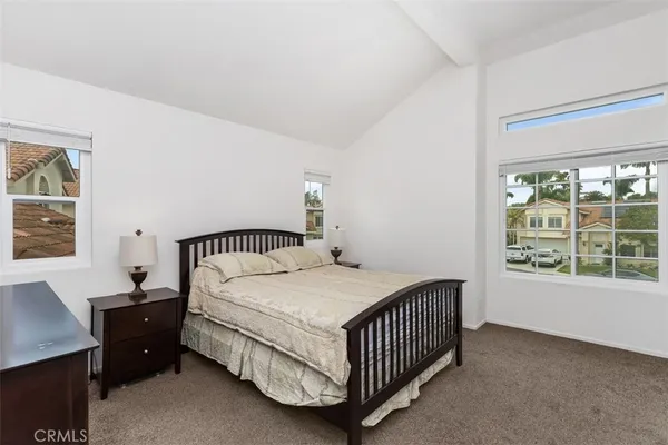 a bedroom with a bed window and a bed in it