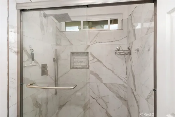 a bathroom with a glass shower door